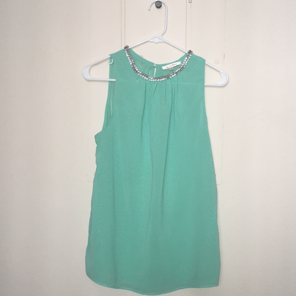 Sleeveless shirt with jeweled neck
